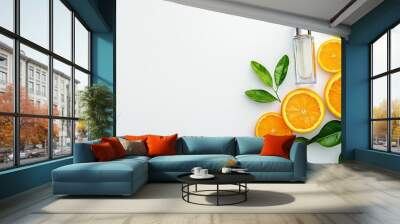   An orange cut in two sits on a table with a bottle of lotion and some leaves beside it Wall mural