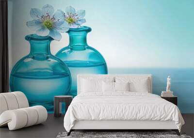 a couple of blue vases sitting on top of a table with a flower in one of the vases. Wall mural