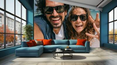 A pair of lovers take a selfie on a tropical beach. Wall mural