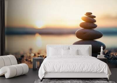 A serene stack of balanced stones on a calm beach, symbolizing peace and mindfulness. Wall mural