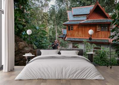 A tourist on an excursion to a mountain temple in Thailand Wall mural