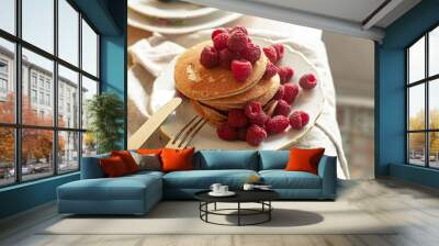 Delicious whole wheat healthy pancakes with raspberry, fork and knife styling natural light and copy space on the table with linen cloth background lifestyle Wall mural