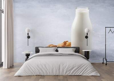 almonds and a bottle of almond milk on a light grey background. Vegan milk. Wall mural