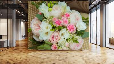 Wedding ring in white gold. Two platinum rings of the bride and groom and a bouquet of pink roses and white flowers Wall mural