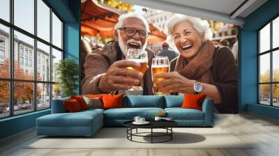 Beautiful sweet happy retired gray haired senior couple laughing, smiling, and drinking beer in amusement park during Oktoberfest festival. Generative AI Wall mural