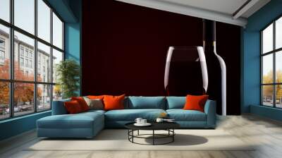 Bottle of red wine and a glass of red wine on a dark background. Wall mural