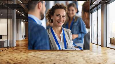 Business conference networking session. A women smiles at a conference. Group of diverse business people in background. Successful business people concept Wall mural