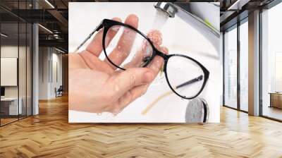 Cleaning eyeglass lenses to be clean and clear to prevent COVID 19 Wall mural