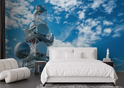 Close up Modern communication tower with multiple satellite dishes blue sky Wall mural