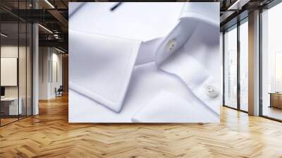 Close-up of a white shirt with buttons on a white background Wall mural