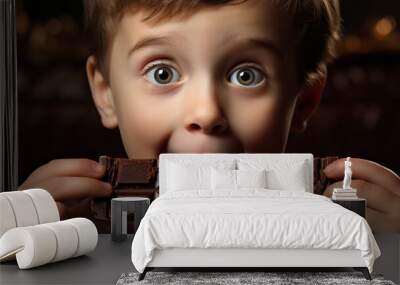 close-up portrait of a boy eating chocolate. the harm of sweets for the teeth. Wall mural