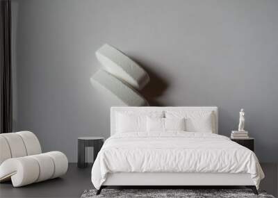 Closeup of 2 big white oblong caplets of calcium citrate Wall mural