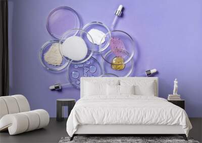 Cosmetic products, scrub, face serum and gel in many petri dishes on a pink background. Cosmetics laboratory research concept. Pastel violet background Wall mural