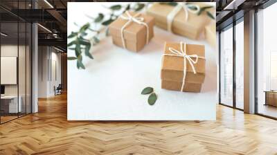 Craft gift boxes on white wooden background. Copy space for text. Eco concept Wall mural