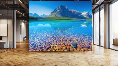 Crystal clear lake with rocky shoreline and majestic mountain range reflections Wall mural