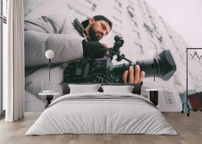 Director of photography with a camera in his hands on the set Wall mural