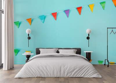 Multicolored paper flags on blue background. Festive concept. Wall mural