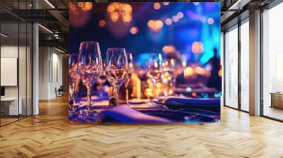 Elegant dining table set with crystal glasses and plates under warm bokeh lights at night event. Concepts of luxury, celebration, fine dining, and festive gatherings Wall mural