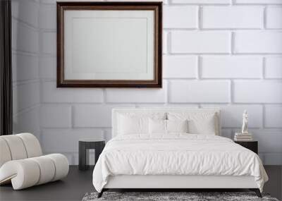 Empty picture frame on a white brick wall. Wall mural