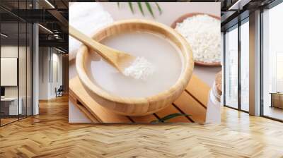 Homemade cosmetic rice water with ingredients on beige background, healthy beauty treatment ingredients for homemade comsetics, beauty recipe for home spa, natural skincare preparation, close up Wall mural