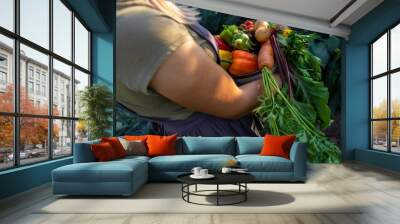 female farmer holding a large plate with various fresh farm vegetables. Autumn harvest Wall mural