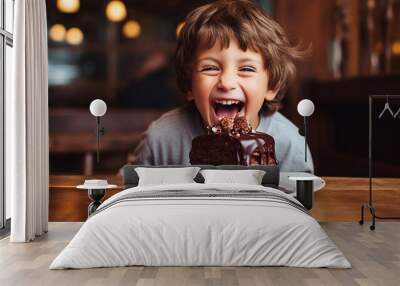 happy child eats chocolate cake. Wall mural