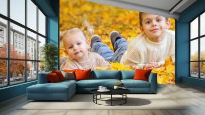 Happy children, boy and little girl in autumn park. Autumn Wall mural