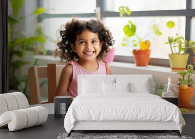 Happy little girl eating healthy breakfast at table in kitchen. Wall mural