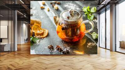 Herbal tea in a glass teapot with spices Wall mural