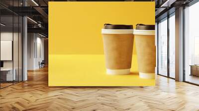 Two paper coffee cups with empty space for your logo on a yellow isolated background with copy space. Street drinks concept. Coffee with you Wall mural