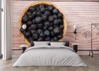 blueberries in a wooden bowl on a wooden background, healthy food, fruit in a bowl Wall mural