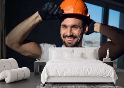 A bearded foreman straightens a construction helmet on his head Wall mural