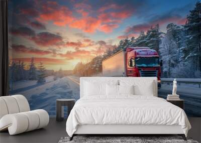 Large truck driving on a road in winter, snow covered landscape and sunset sky background Wall mural