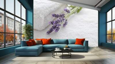 Lavender on soft white towels, symbolizing spa and relaxation Wall mural