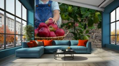 little girl eats an apple in the garden. Selective focus Wall mural