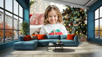 Little girl with Chritmas present. Wall mural