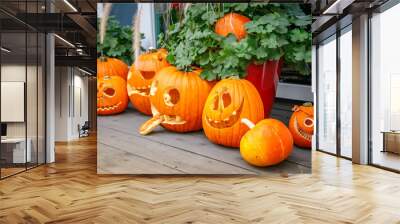 A collection of Halloween pumpkins, each carved with unique expressions Wall mural