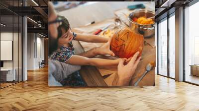 Little girl and her father holding a Halloween pumpkin Wall mural