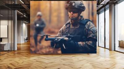 Man in military uniform with quadcopter in the autumn forest. Wall mural