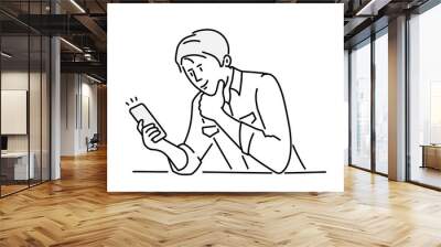 Man sitting at table and using phone. Hand drawn vector illustration. Wall mural