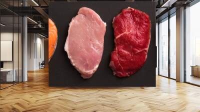 Meat collection on dark background. Beef, pork, chicken, fish isolated on black. Set of natural food. Top view. Flat lay. Wall mural