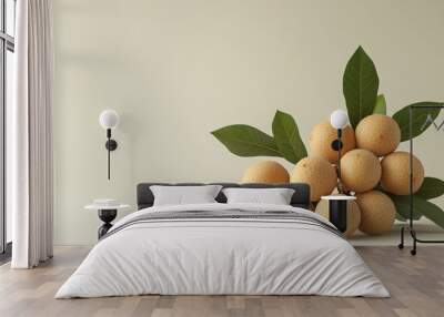 Minimalistic longan fruit display with leaves on beige Wall mural