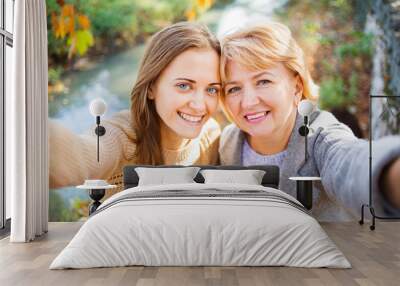 Mother and adult daughter outdoor in park. Wall mural