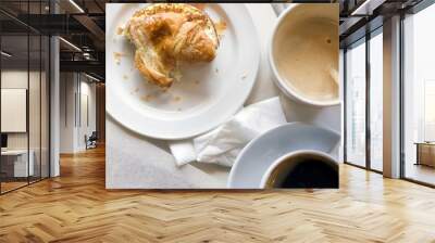 Not finished breakfast with croissant and coffee soft focus on the table, sunlight, toned. Top view, close up, copy space Wall mural