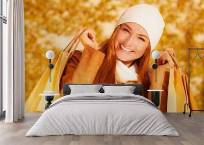 Cheerful woman with paper bags Wall mural