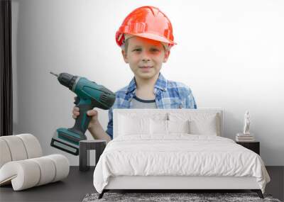 A cute preschooler is standing with a screw gun in his hand and holding a self-tapping screw in the other. Isolated child on a white background, horizontal photo. Wall mural