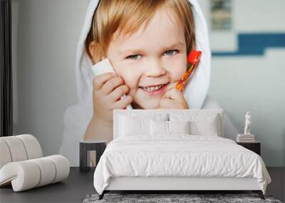 Portrait of a cute child with toothbrush and toothpaste in the bathroom. Wall mural