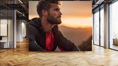 Portrait of an athlete in the mountains in the setting sun. Wall mural