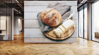 Fresh homemade bread and butter on a wooden table Wall mural