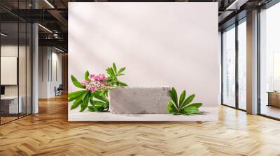 Minimal concrete background for branding and packaging presentation. Textured stone on beige background with lupine flowers Wall mural